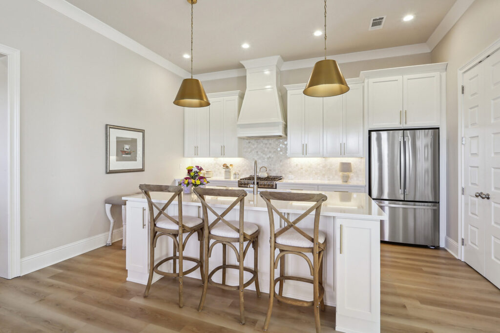 Beautiful white kitchen with island by Highland Homes, Dalmore